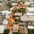 Aerial view of the park demolition site with construction equipment and cleared land.