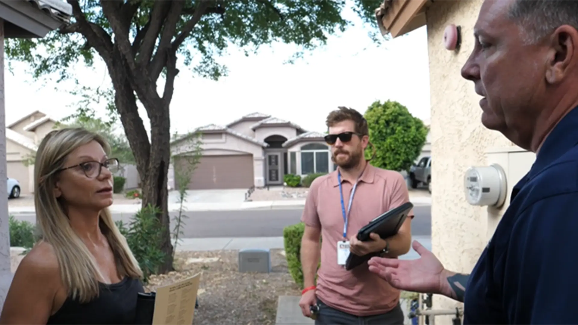 Scottsdale resident discussing an outdoor water efficiency check with two staff from scottdsale water
